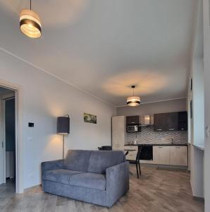 a living room with a couch and a kitchen at Via Casne 2 Volpiano (TO) in Volpiano