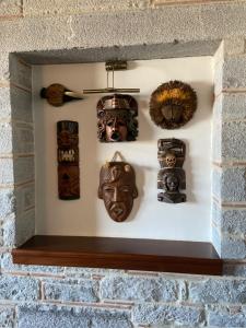 a wall with masks on a brick wall at Villa Castello in Bodrum City