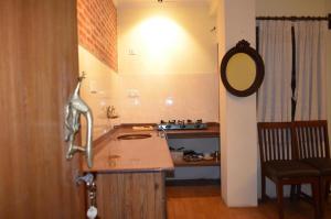 a kitchen with a sink and a counter with a mirror at Newa Home in Kathmandu