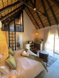 a bedroom with a large bed in a room at Arnhem Cave Lodge in Omitara