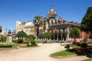 a large building with a courtyard in front of it at Apartamento Cantabrico vistas a la Ría deRibadeo in Ribadeo