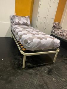 a bed sitting on a metal frame in a room at Hostal garbatella in Rome