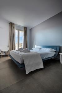 Postel nebo postele na pokoji v ubytování Serafini Rooms