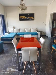 a dining room with a red table and white chairs at Piraeus yacht view apartment in Piraeus