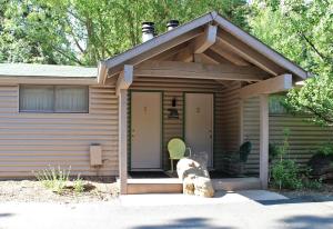 a log cabin with a roof and a porch at Sunnyside Knoll- 1 studio in Estes Park +2 photos