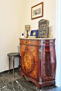 an old wooden cabinet with a suitcase on top of it at Piraeus yacht view apartment in Piraeus