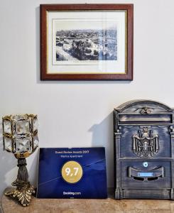 a box next to a dresser with a picture on the wall at Piraeus yacht view apartment in Piraeus