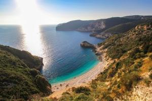 Blick auf einen Strand auf einem Hügel mit dem Meer in der Unterkunft Bask in the Beauty of Paxoi - Kirki's Summer Retreats with Private Jacuzzis in Ieromónachos