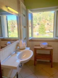 bagno con lavandino, vasca e finestra di Le Casette di Olga -Space for Nature and Sport Lovers- a Baone