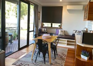 a kitchen and living room with a table and chairs at The Nest - Relax & Unwind with Breathtaking Views over Lake Taupo in Taupo