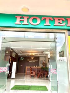 a store front of a hotel with a sign at Green Ville Hotel Đồng Nai in Xa Dau Giay