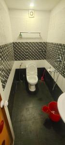 a bathroom with a toilet and a sink at Coastal Cabana Marari in Mararikulam