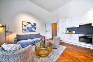 a living room with a couch and a table at Smile Apartments am Stadtpark in Krems an der Donau