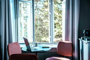 a laptop sitting on a table in front of a window at Hotel Filip in Oslo