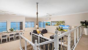 a living room with a view of the ocean at Zahirs Retreat in North Arm Cove