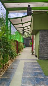 a covered walkway in a building with a green roof at PPH Living Athithi Inn Corporate Stay in Coimbatore