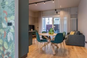 uma sala de jantar e sala de estar com mesa e cadeiras em Green Luxury Apartment by Wonderful Italy em Turim