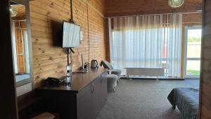 a room with a desk and a room with a bed at Садиба Буланово in Bulanove