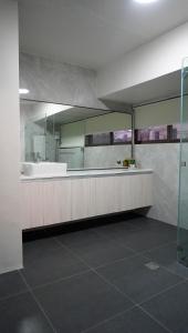 a bathroom with a tub and a large mirror at Honey Suite Room Inside Bee Cafe Cebu at Ayala Area in Cebu City