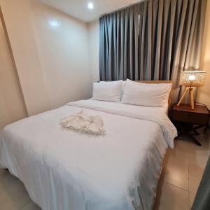 a hotel room with a bed with a towel on it at Urban Homes Bohol in Tagbilaran City