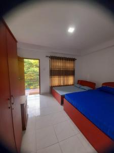 a bedroom with two beds and a window at Artomoro Ceylon motel in Demodera
