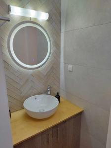 a bathroom with a white sink and a mirror at Petmeza Top Aigio City F in Aigio +21 photos