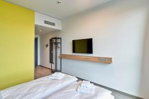 Postel nebo postele na pokoji v ubytování MEININGER Hotel Köln West