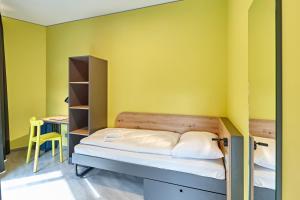 Postel nebo postele na pokoji v ubytování MEININGER Hotel Köln West