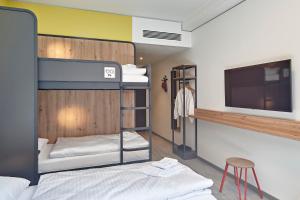 Postel nebo postele na pokoji v ubytování MEININGER Hotel Köln West
