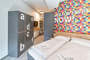 Postel nebo postele na pokoji v ubytování MEININGER Hotel Köln West