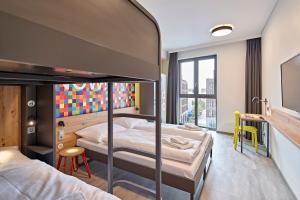 Postel nebo postele na pokoji v ubytování MEININGER Hotel Köln West