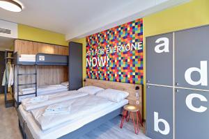 Postel nebo postele na pokoji v ubytování MEININGER Hotel Köln West