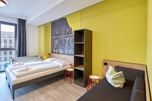 Postel nebo postele na pokoji v ubytování MEININGER Hotel Köln West
