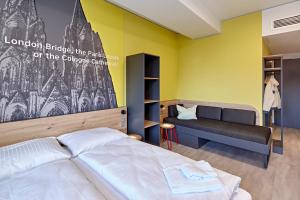 Postel nebo postele na pokoji v ubytování MEININGER Hotel Köln West