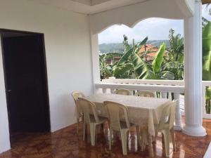 a dining room with a table and chairs and a window at Cebu City 3 bedrooms split house 2nd floor-WIFI in Cebu City