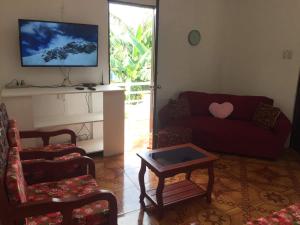 a living room with a couch and a table at Cebu City 3 bedrooms split house 2nd floor-WIFI in Cebu City