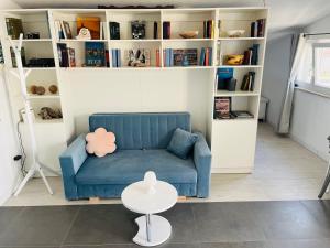 a living room with a blue couch and a table at Apartment Laguna in Vinišće