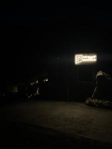 a dark room with a sign in the dark at the suwgra-Al-Jabal Al-Akdar in Sūkirah
