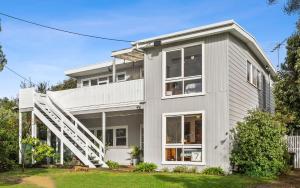 a house with a staircase in front of it at Two houses from the beach 100m to Sand and Surf Sea Views in Torquay