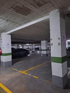 a parking garage with a car parked in it at Macflats Ciudad de las Ciencias in Valencia
