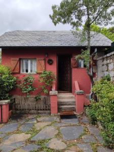 a red house with a red door at Casita Roja sin cocina in Cercedilla