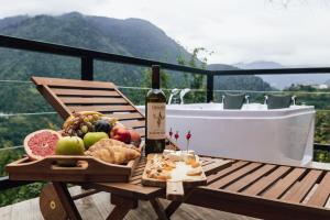 a bottle of wine and a basket of food on a table at Unique Boutique Hotel Near Batumi in Batumi