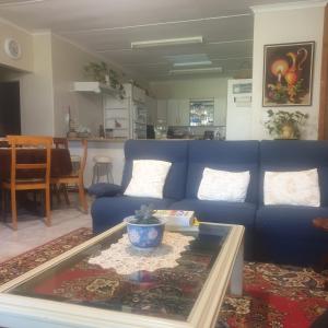 sala de estar con sofá azul y mesa en IRMAS FARMSTAY AT NUYVALLEY GUESTFARM, en Nuy