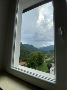 a window with a view of the mountains at Albergo Lodrino in Villa