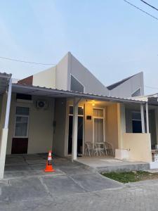 a house with an orange cone in front of it at Villa Ku Villa Mu in Semarang