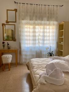 a bedroom with a bed and a mirror and a window at Casa Vacanza Lilia vicino la Stazione e Caserma in Foligno