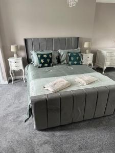 a bedroom with a large bed with two pillows at Cameron Coach House Modern Property in Murrayfield Edinburgh in Edinburgh