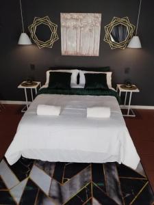 a bedroom with a large bed with two tables at Royal Inn Room 2 in Kimberley