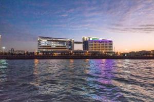 a group of buildings on the shore of a body of water at Holiday Inn Express Xiamen Airport Zone, an IHG Hotel in Xiamen