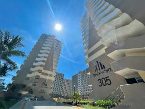 a view of two tall buildings in a city at Condo with resort-like living, everyday in Lapu Lapu City